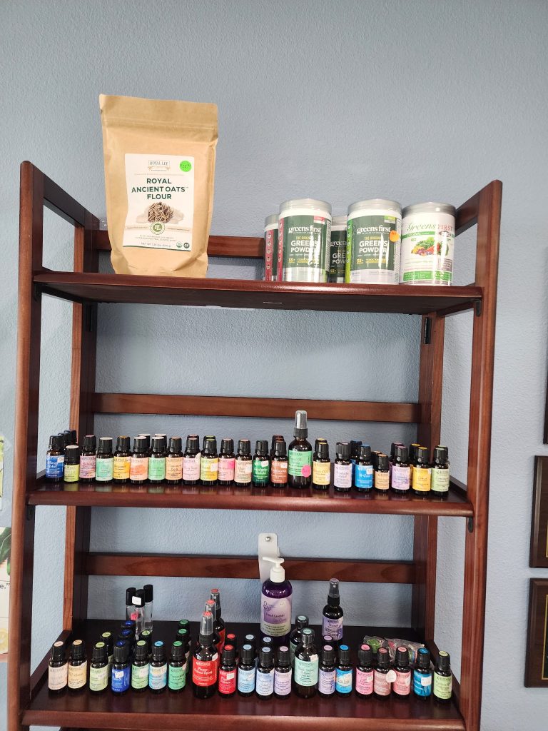 Rows of essential oil and tincture dropper bottles on a dark wooden shelf